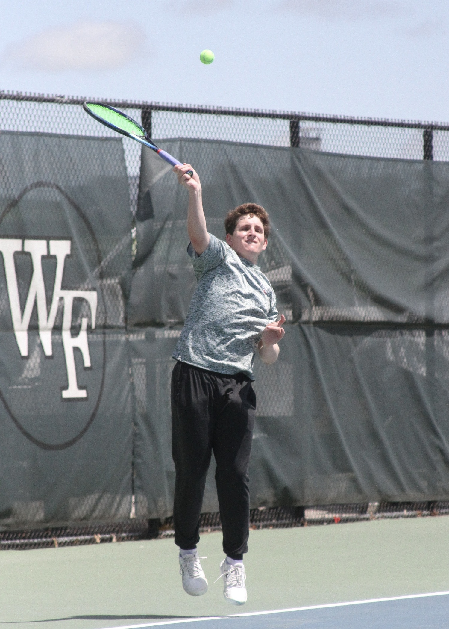 Junior Robby Schumacher serves. DESIRÉE KEEGAN