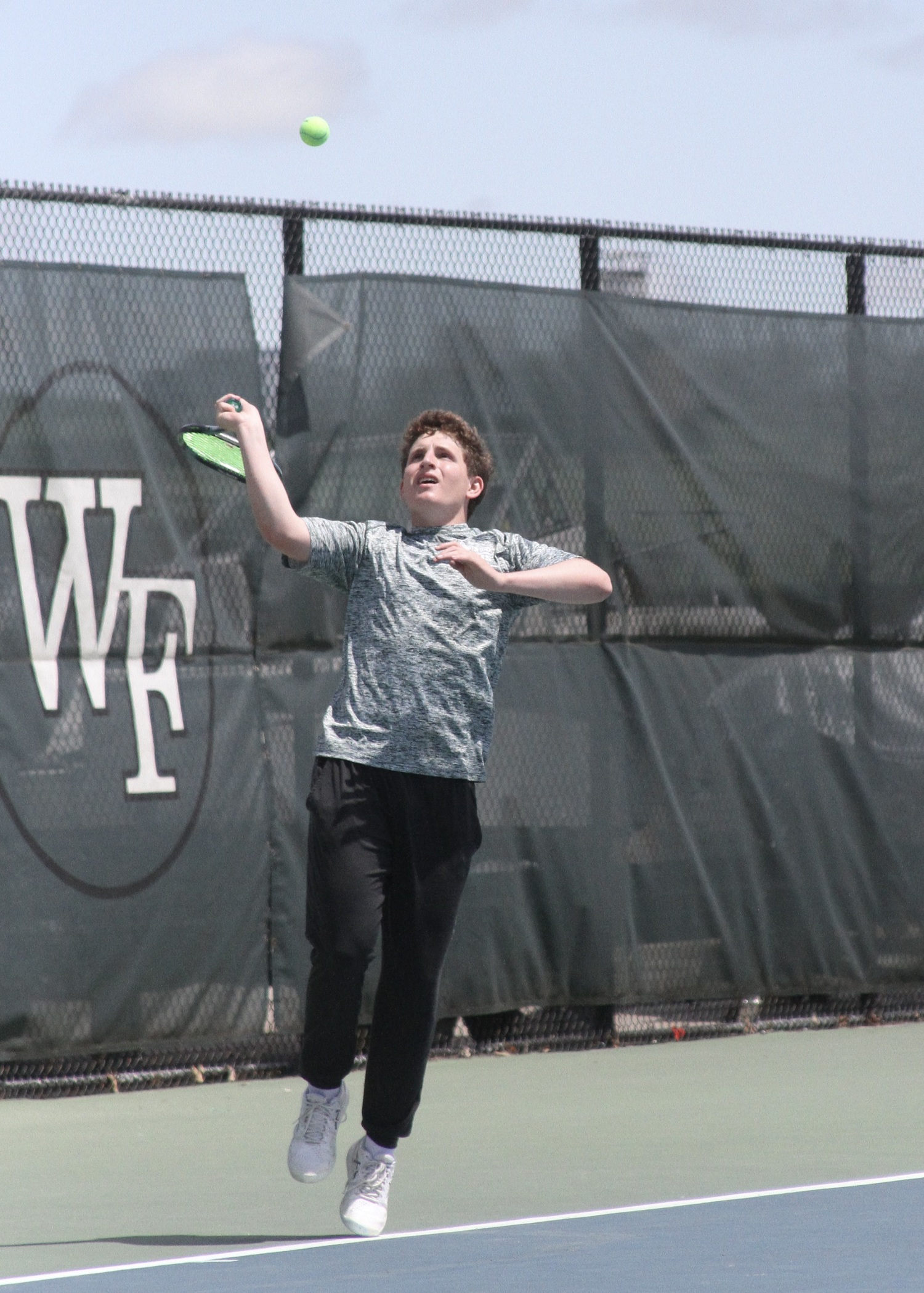 Junior Robby Schumacher serves. DESIRÉE KEEGAN
