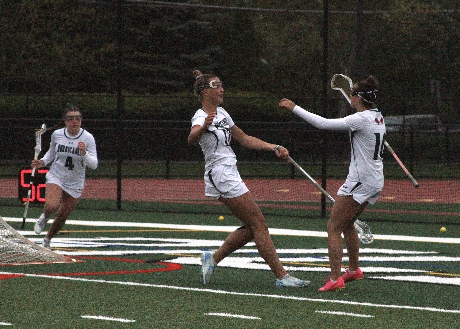 Senior midfielder Reese King reaches for freshman attack Mia Mastropierro in celebration of her goal. DESIRÉE KEEGAN