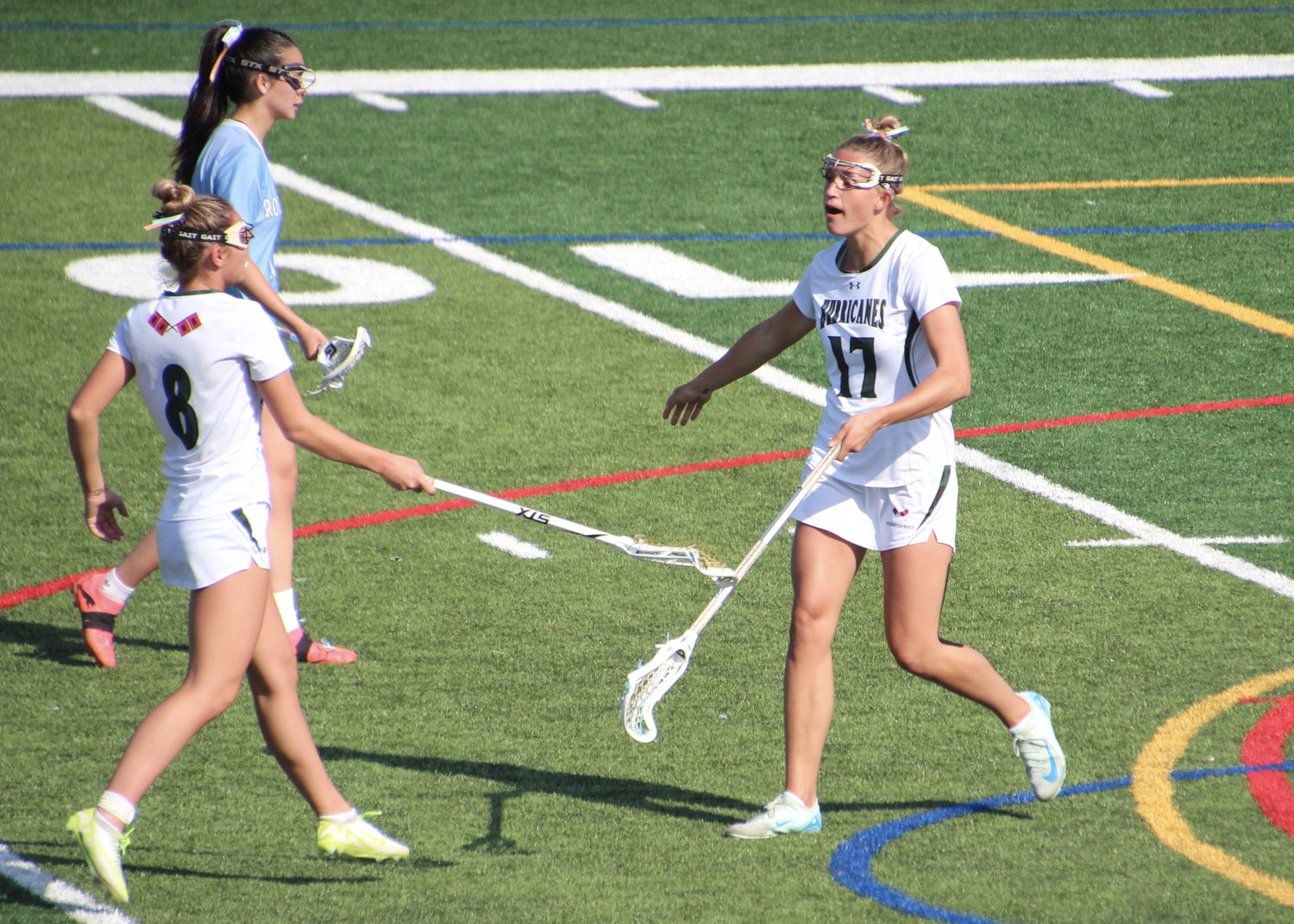 Senior midfielder Reese King celebrates scoring a goal with junior attack Ava Derby. MARY BEASLEY
