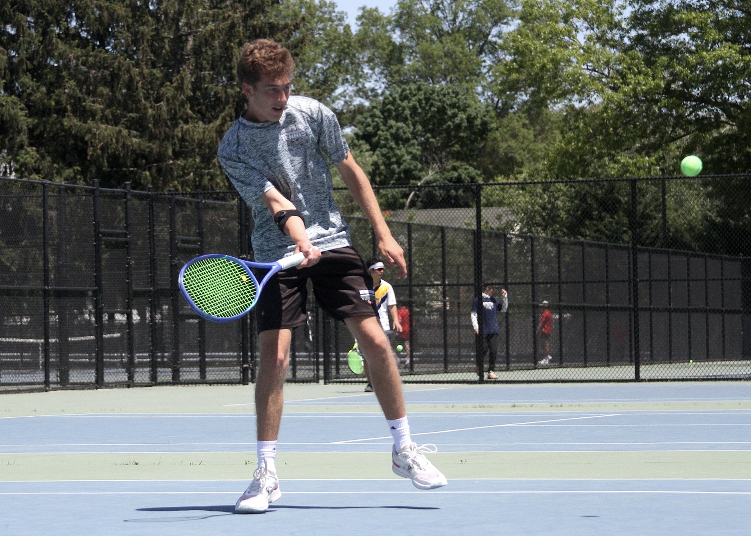 Junior Bryce Groth sends the ball back over the net. DESIRÉE KEEGAN