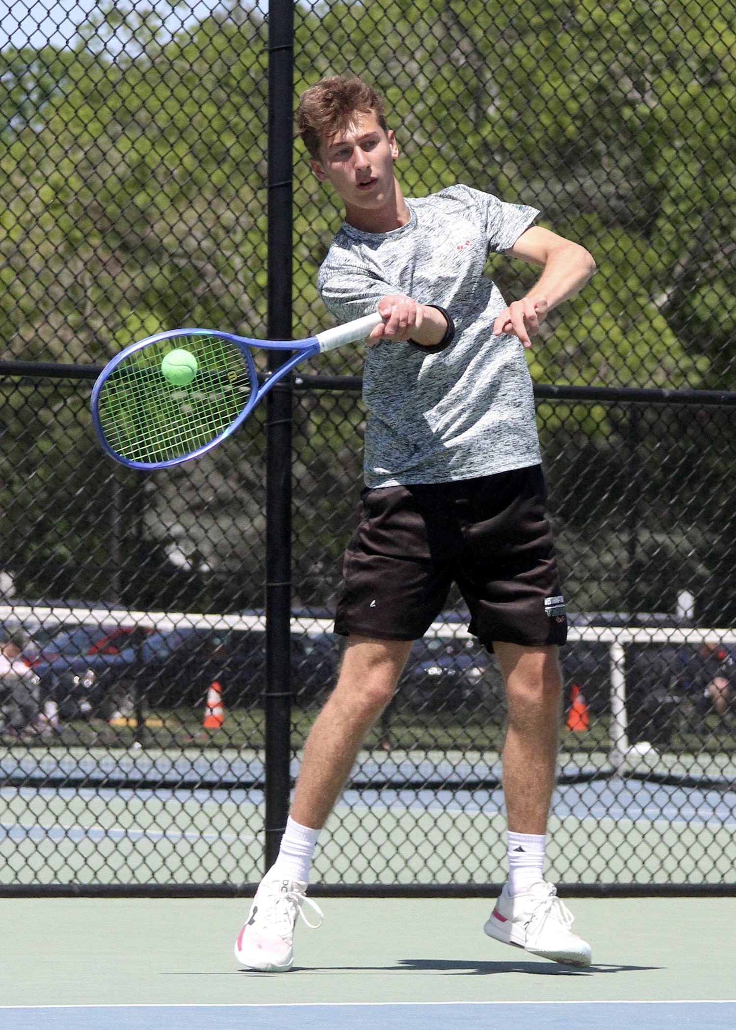 Junior Bryce Groth sends the ball back over the net. DESIRÉE KEEGAN
