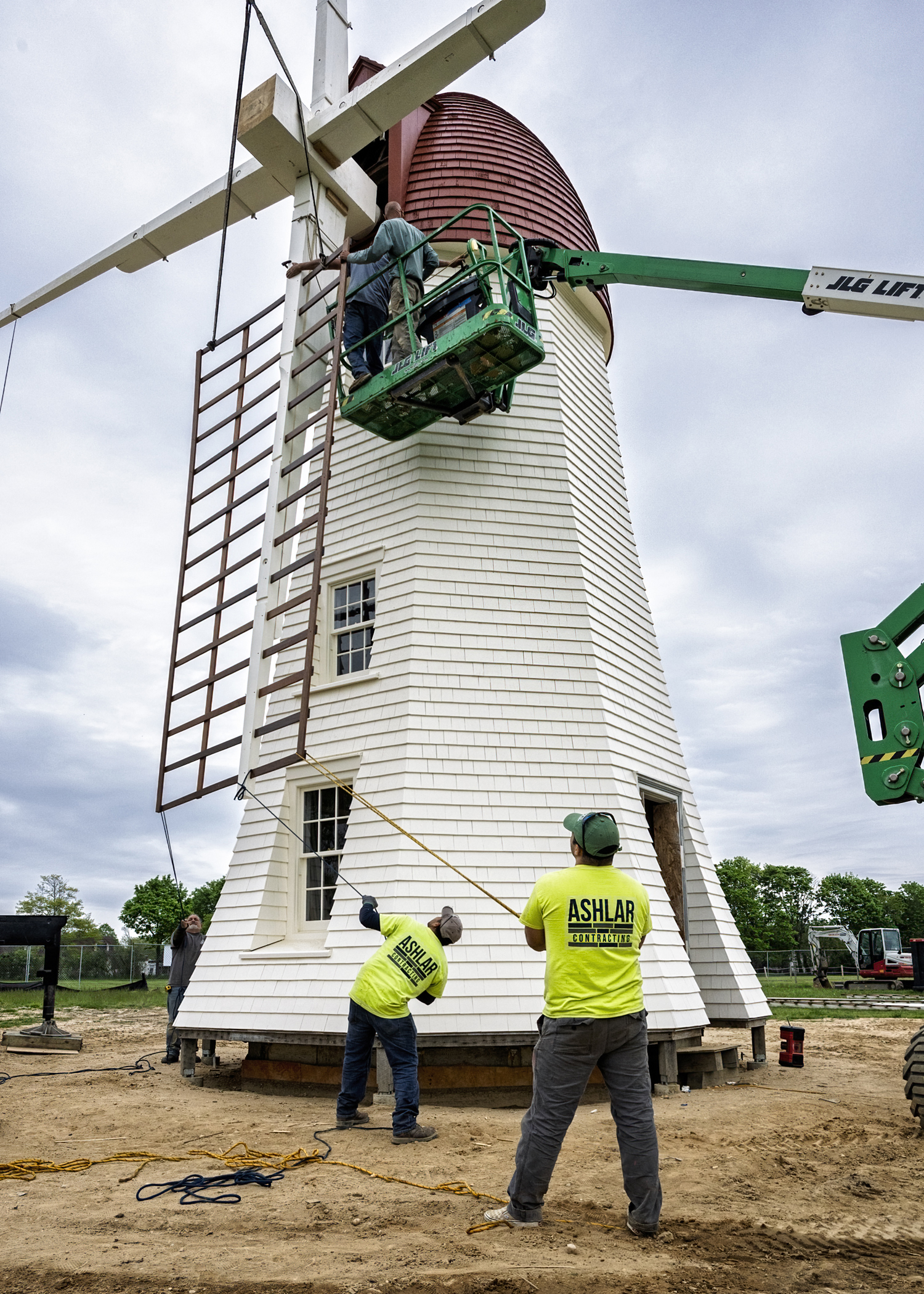 On May 13, a crew works to install the blades on the windmill that resides on the Great Lawn in Westhampton Beach.  JOHN NEELY