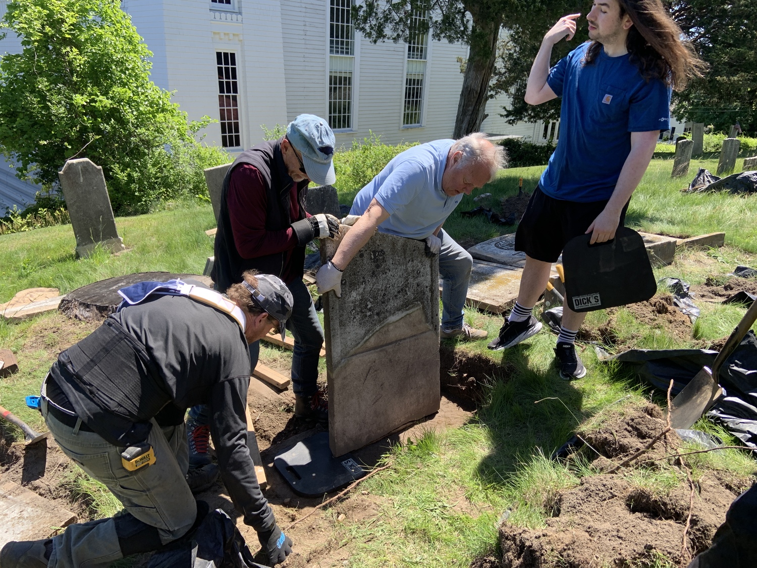 A team of volunteers moves a Beebee family headstone back into position. STEPHEN J. KOTZ
