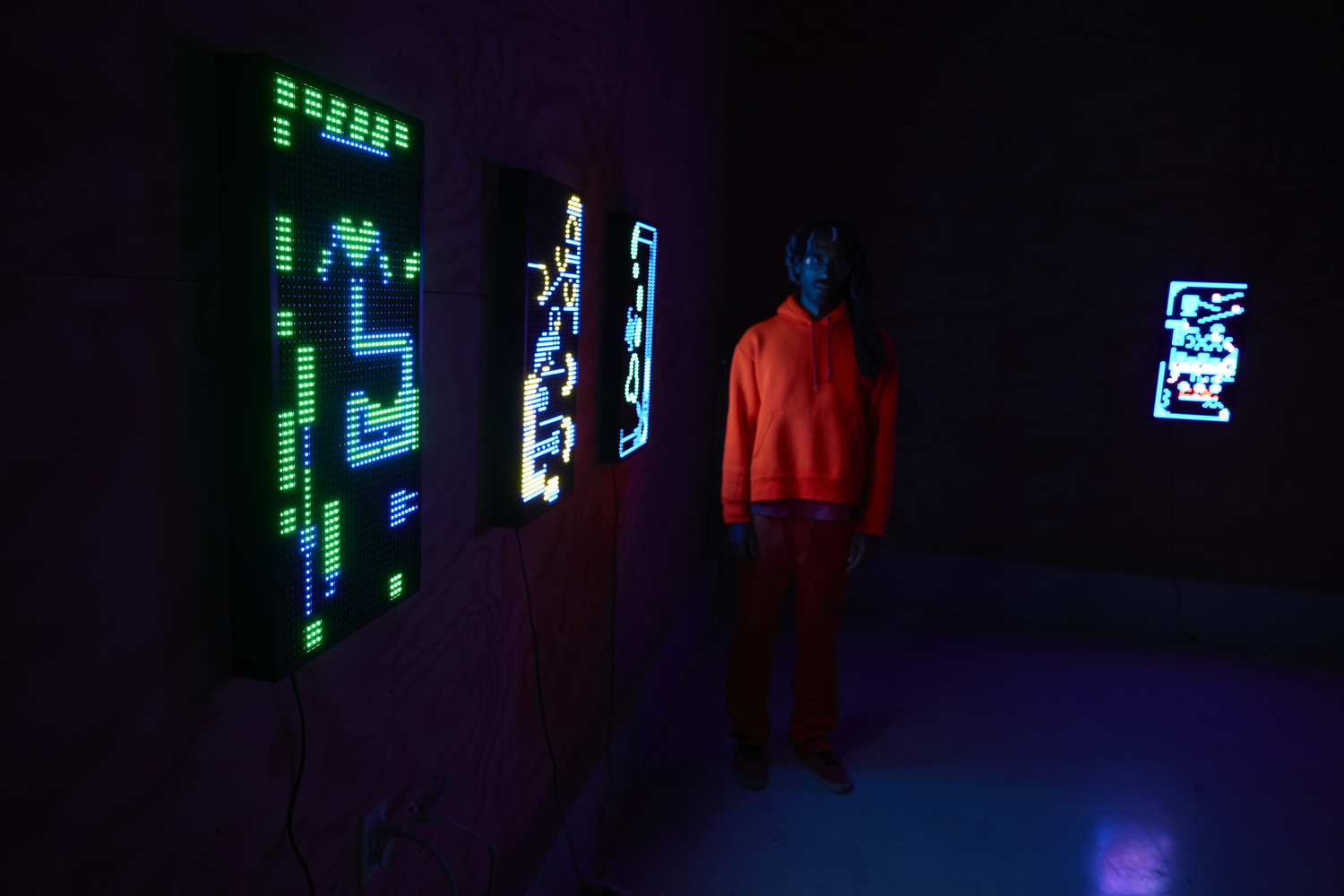Yung Jake in front of new works on view in 
