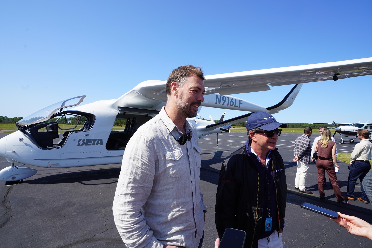 Beta Technologies Kyle Clark, left, and Blade CEO Rob Wiesenthal, right, take questions from the media before boarding an electric aircraft bound for JFK International Airport. DOUG KUNTZ