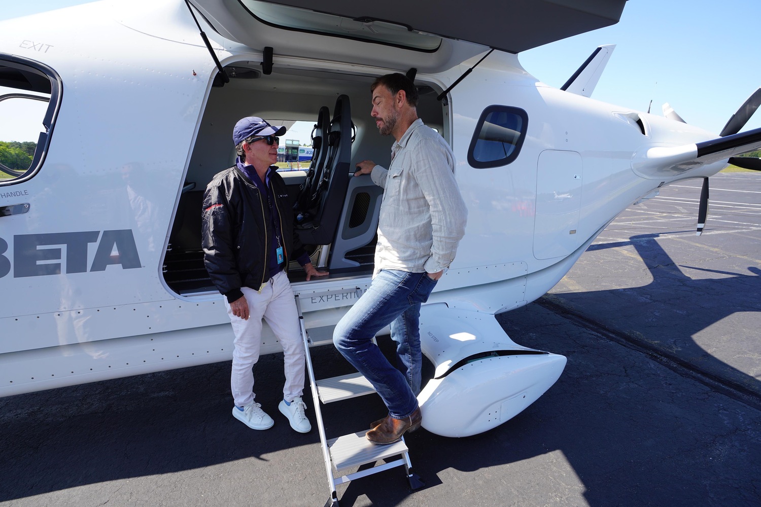 Blade CEO Rob Wiesenthal, left, and Beta Technologies CEO Kyle Clark, right, get ready to board an electric aircraft headed for JFK International Airport. The flight was expected to take 38 to 45 minutes. DOUG KUNTZ