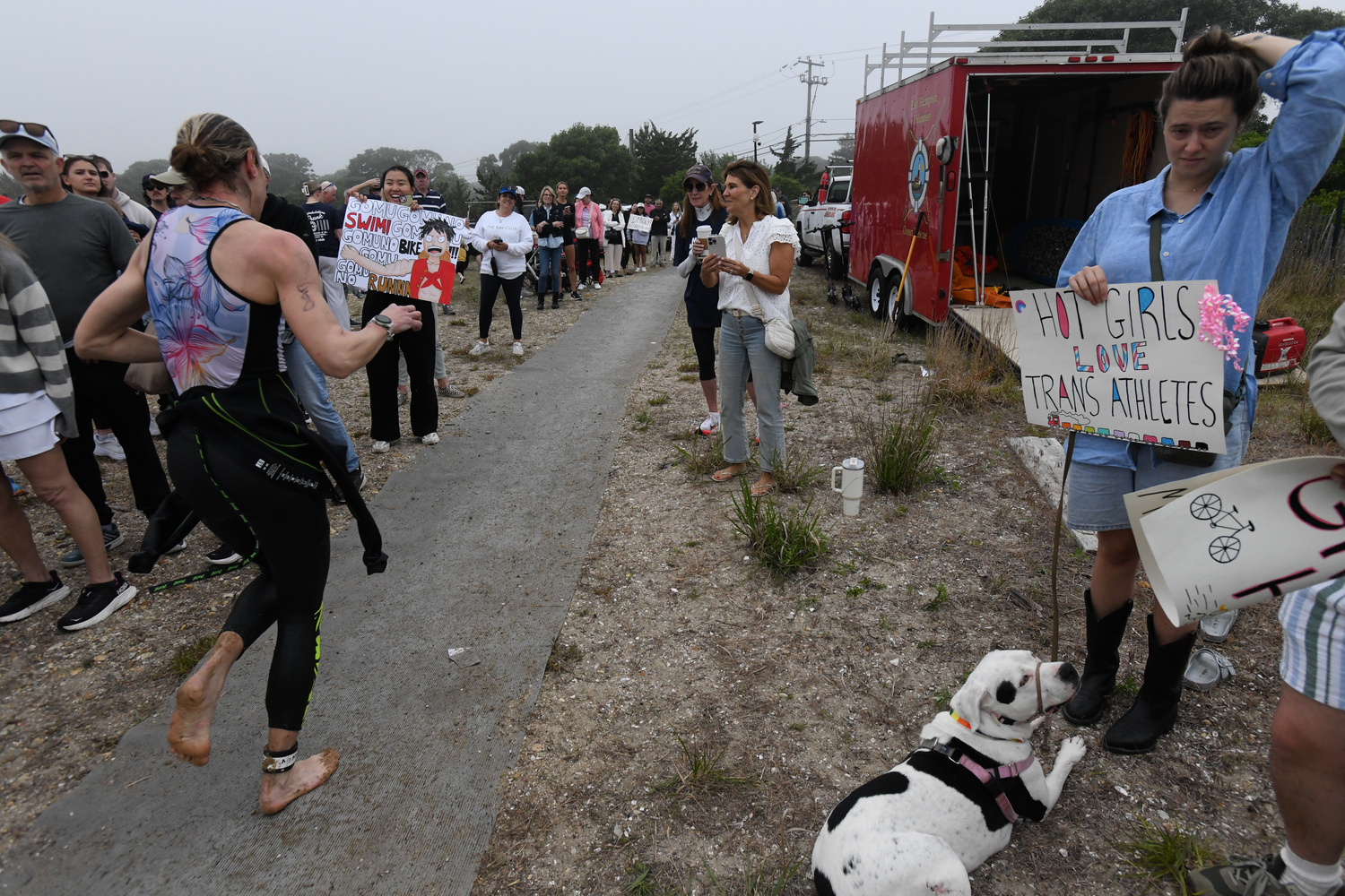 Supporters with signs at the RJA Memorial Mighty Montauk Triathlon on Saturday morning.   DOUG KUNTZ