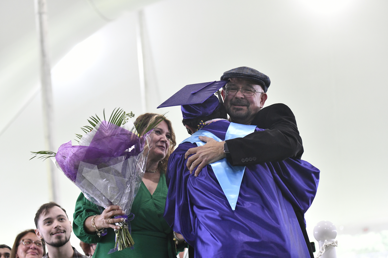 Valedictorian Christopher Roldan gets a hug from his family.  DANA SHAW