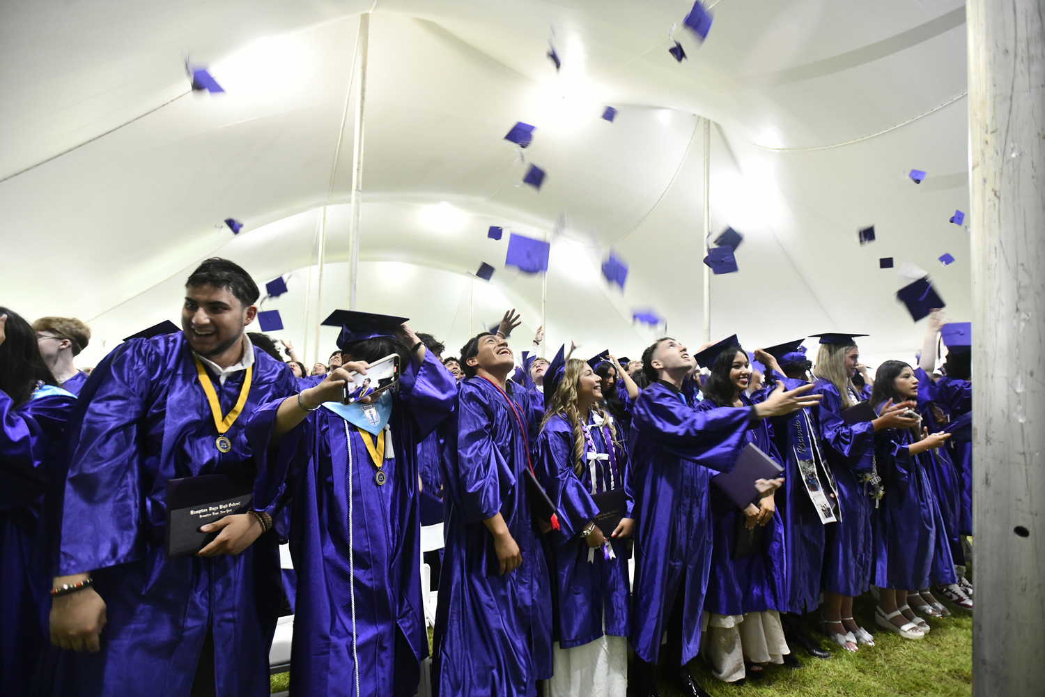 Members of the Class of 2025 throw their caps.  DANA SHAW