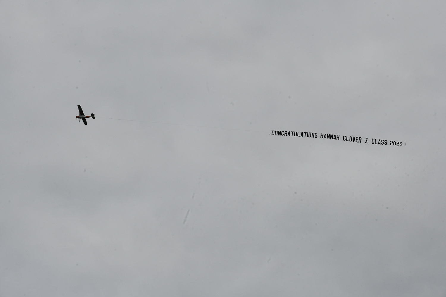Westhampton Beach High School graduate Hanna Glover gets a sky message.  DANA SHAW