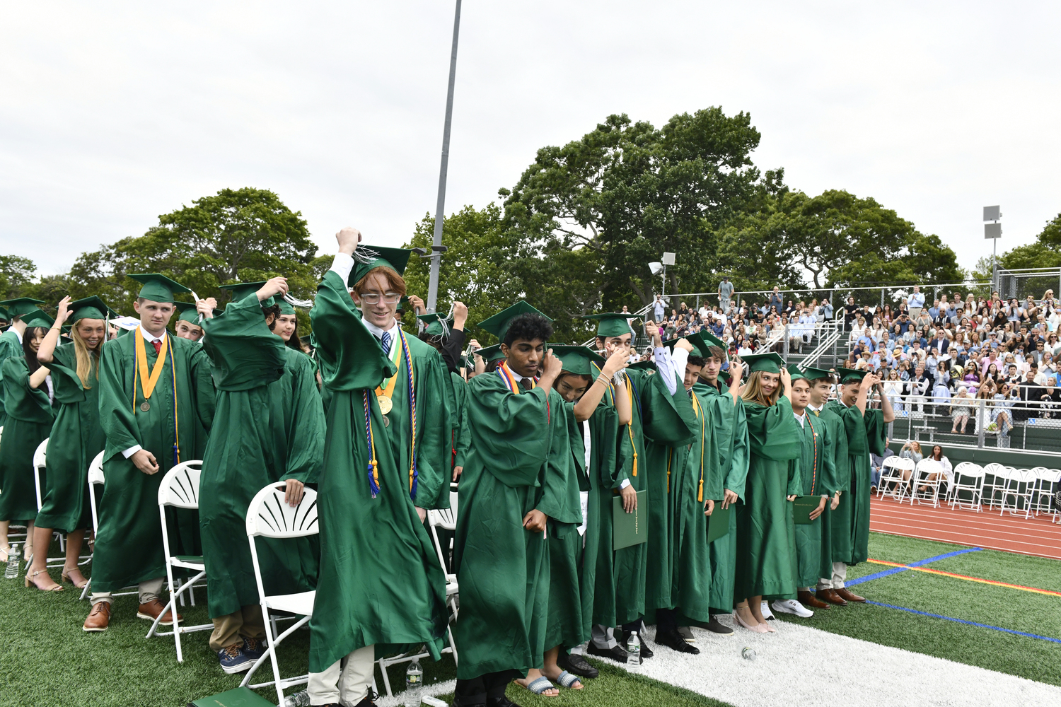 The graduates move their tassels.  DANA SHAW