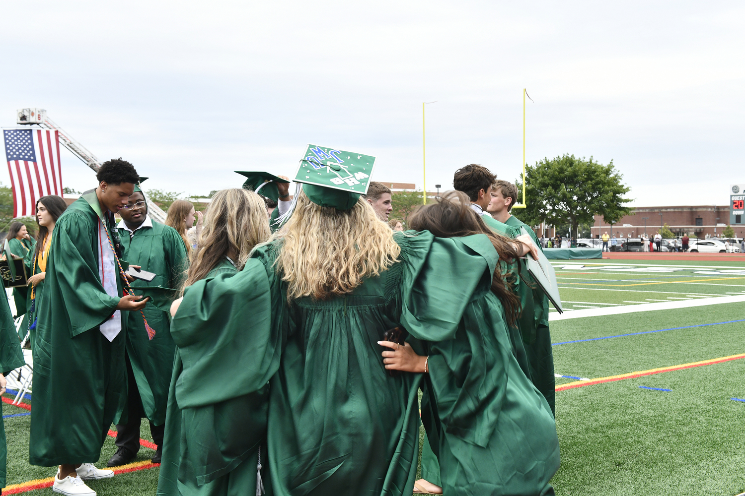 Friends celebrate after graduation.  DANA SHAW