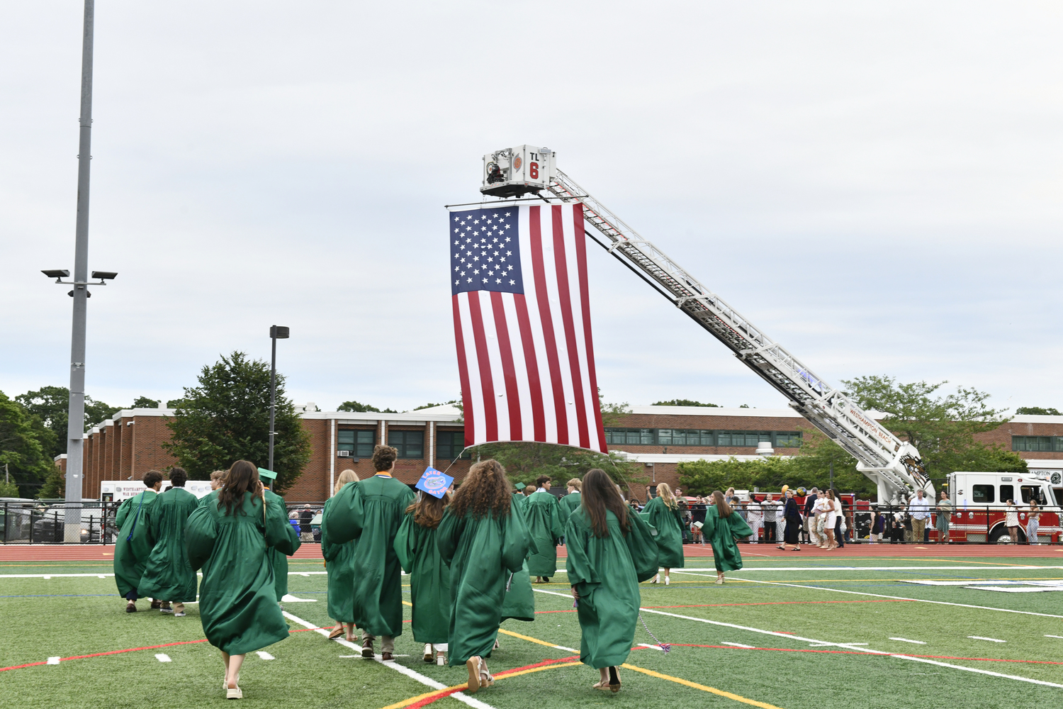 The graduates leave the field.  DANA SHAW