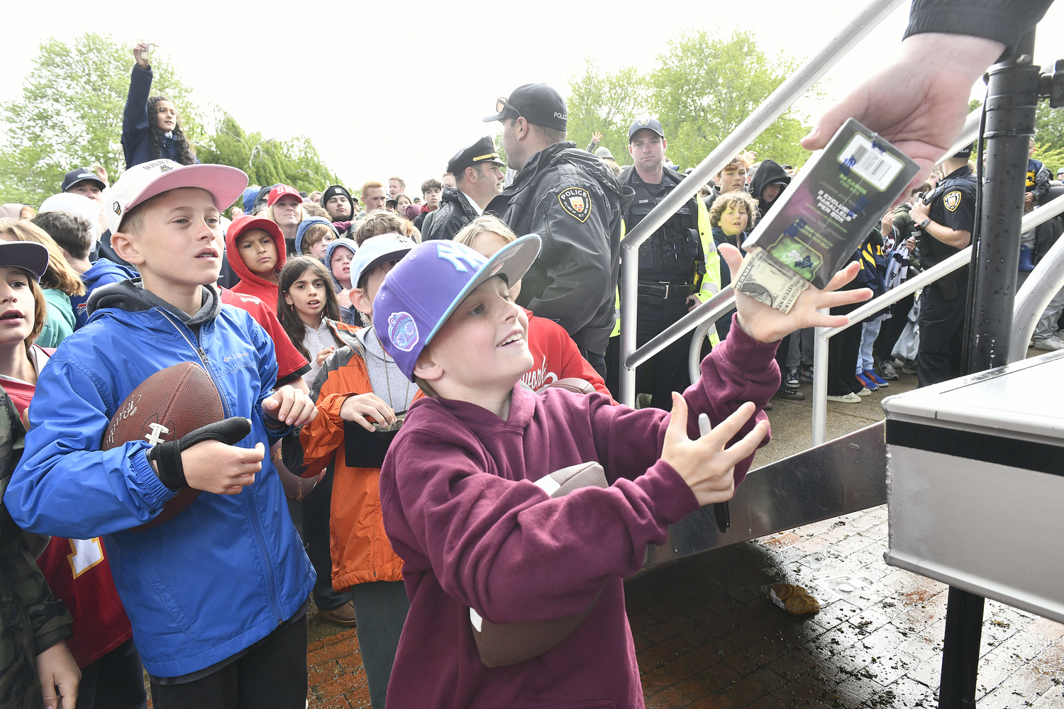 A young collector receives a pack of sports cards in Herrick Park in East Hampton on May 22.  DANA SHAW