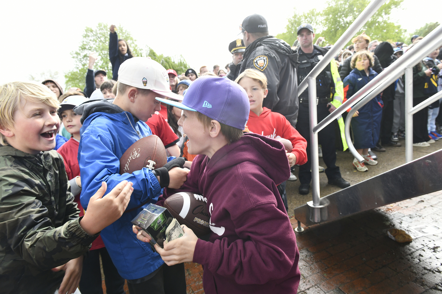 A young collector reacts after receiving a pack of sports cards in Herrick Park in East Hampton on May 22.  DANA SHAW