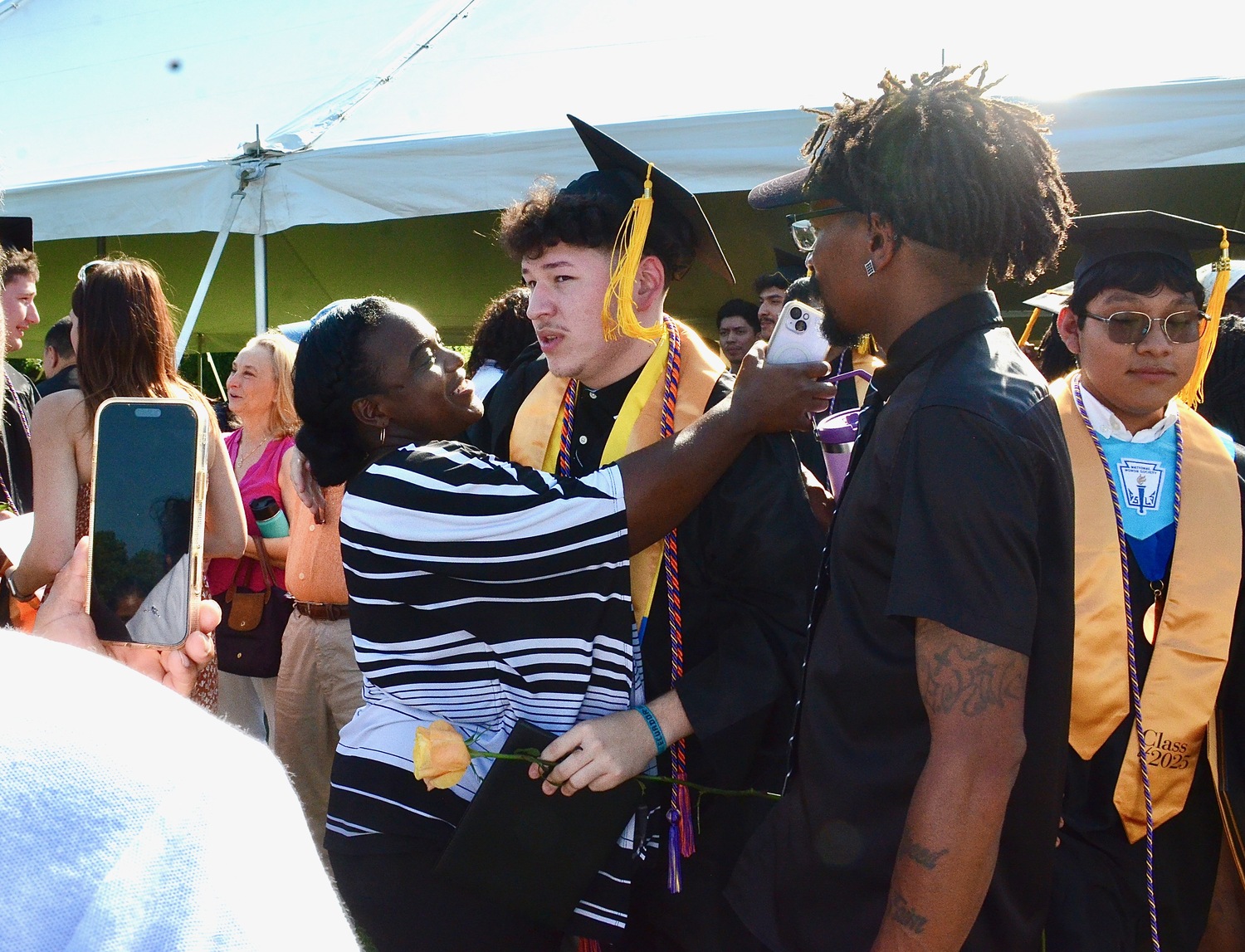 Graduates celebrate with friends and family after the ceremony.  KYRIL BROMLEY