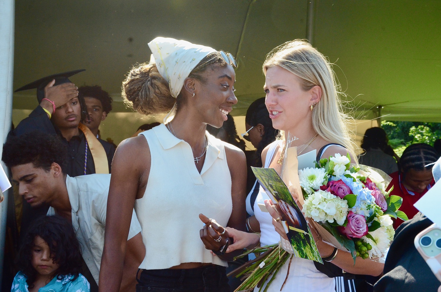 Graduates celebrate with friends and family after the ceremony.  KYRIL BROMLEY