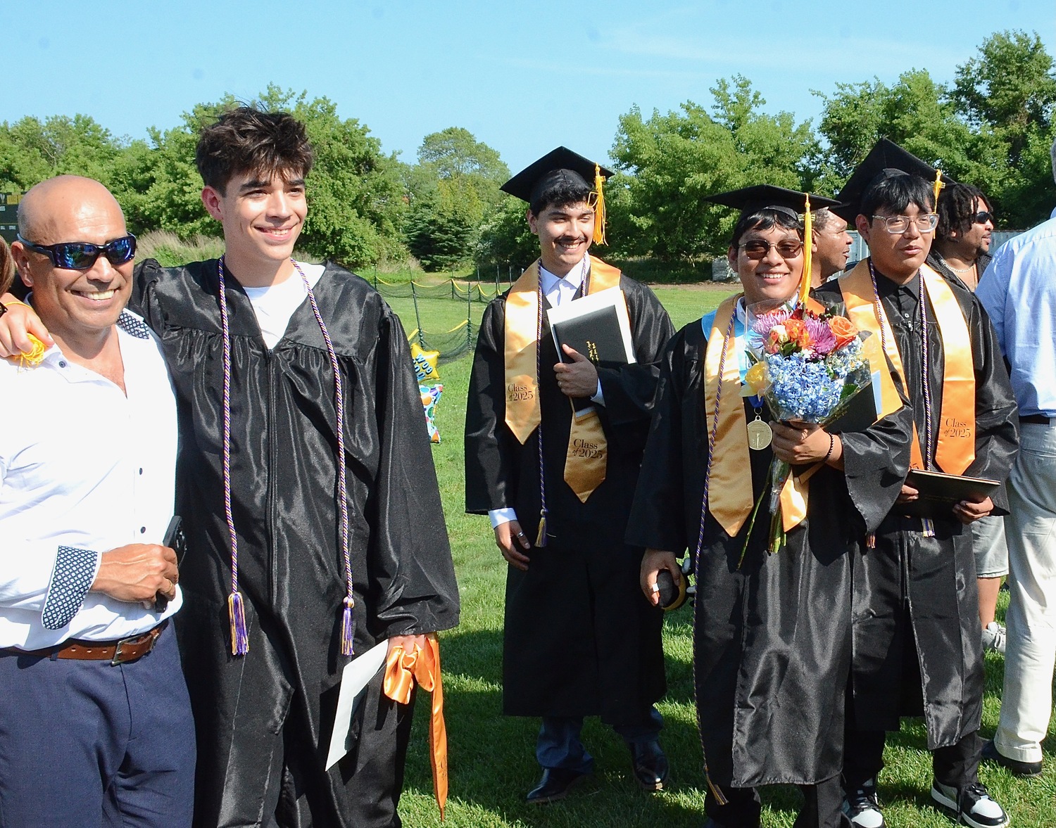Graduates celebrate with friends and family after the ceremony.  KYRIL BROMLEY