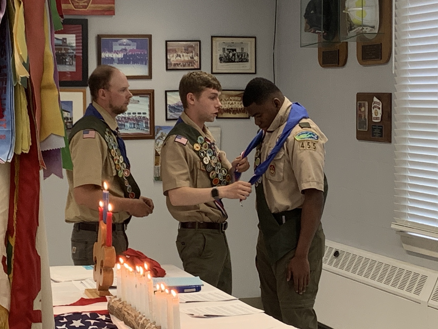 Eagle Scouts James Froelich, left, and Tristan Remkus assist new Eagle Scout Keanu King with his kerchief at a Court of Honor ceremony on Sunday. STEPHEN J. KOTZ