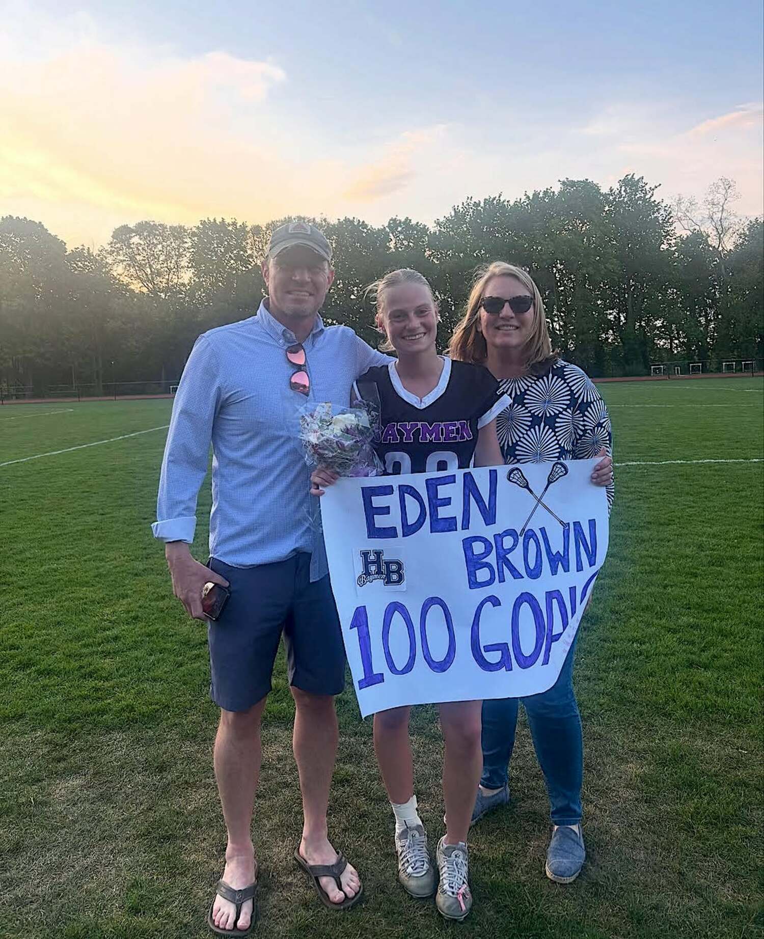 Junior Eden Brown with parents Noah and  after a 14-13 win over Port JeffersonMay 2, where she eclipsed 100 career goals. COURTESY EDEN BROWN