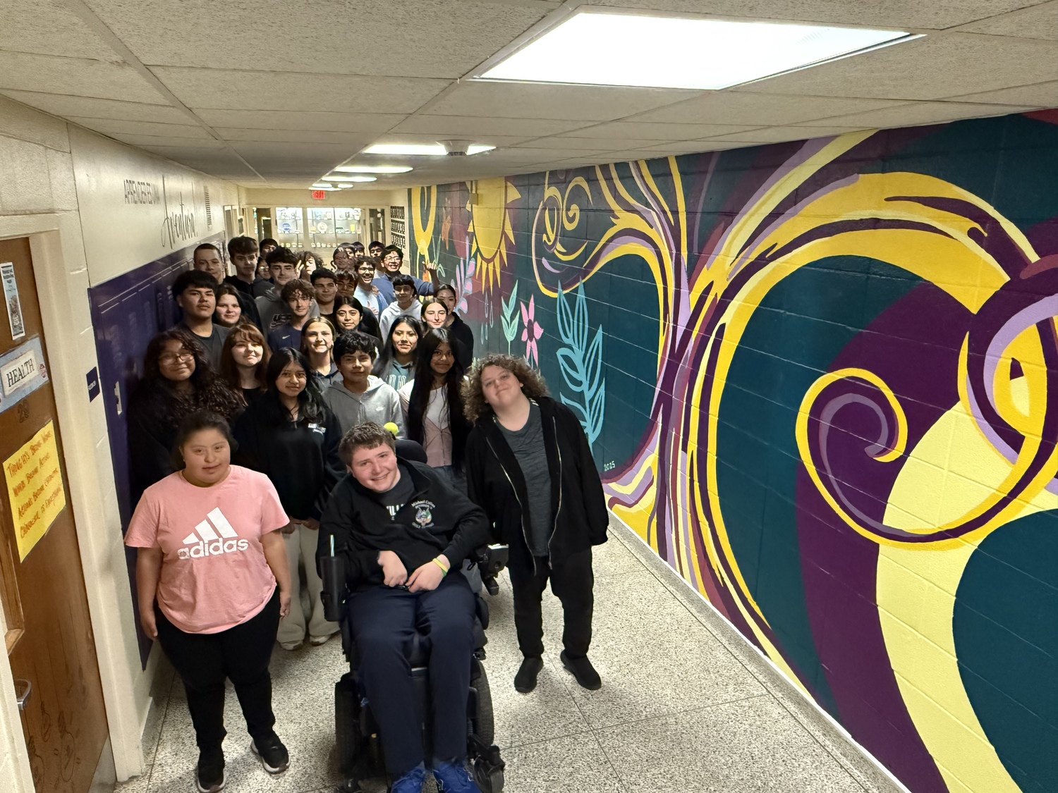A colorful new mural now adorns the business course hallway at Hampton Bays High School. The 300-square-foot mural is the product of more than100 students working together, alongside local artist Maria Fumai Dietrich. During the course of a week, the students painted and sketched the various images that are incorporated in the mural, which carries the theme of “growth.” It features brightly colored flowers, plants and butterflies. This is the second mural that students have painted on the high school’s walls. In 2022, students worked with professional muralist Joe Pimentel on a mural in the school’s main hallway. It incorporates the theme of “Through Our Eyes,” aimed at promoting unity among students while engaging them in something positive. COURTESY HAMPTON BAYS SCHOOL DISTRICT