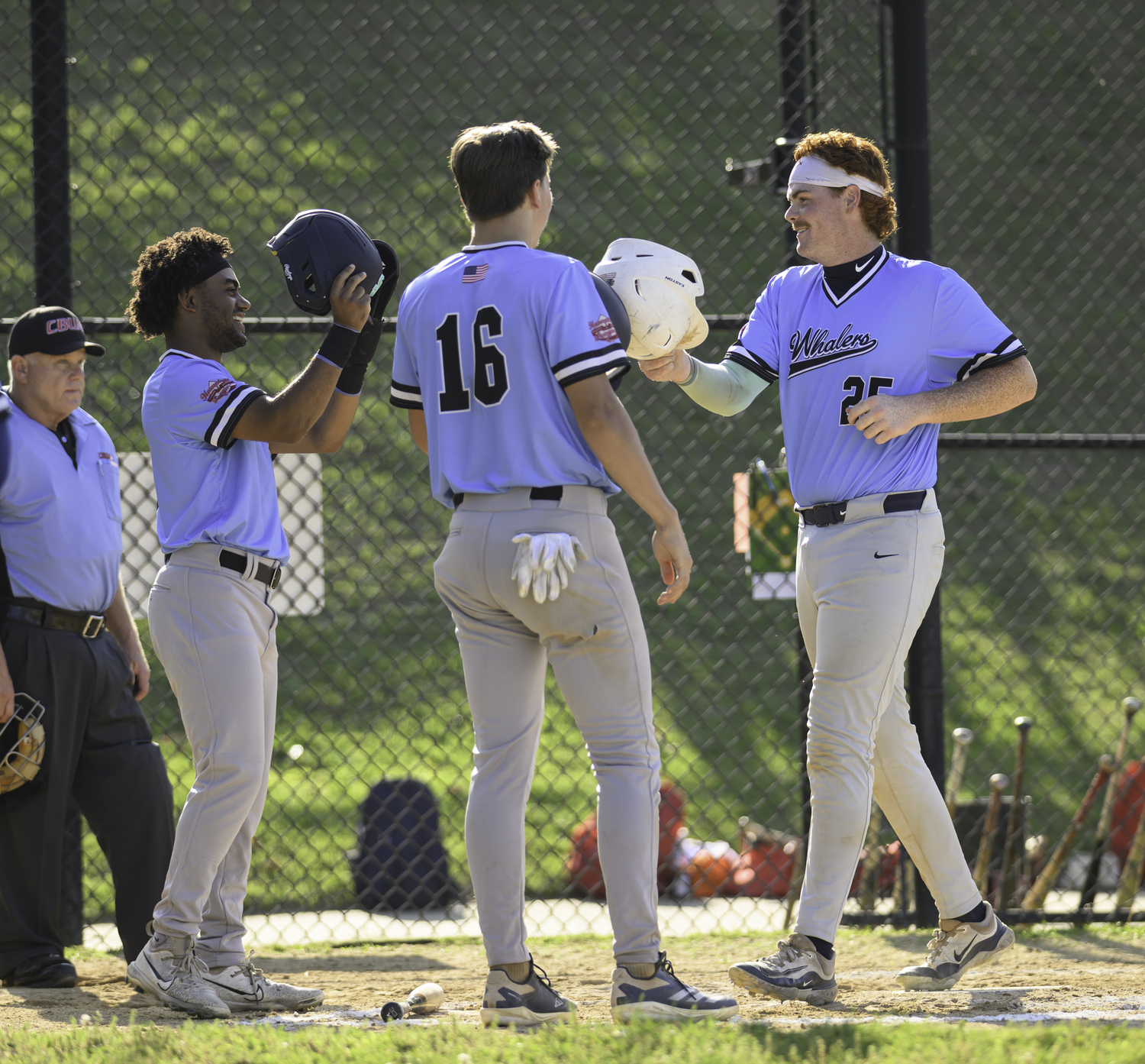 Kieran Shea (St. John's University) is greeted by teammates Dylan Kennedy-Fujah and Jaxon Beiswenger after Tyler Sirchia's grand slam.  MARIANNE BARNETT
