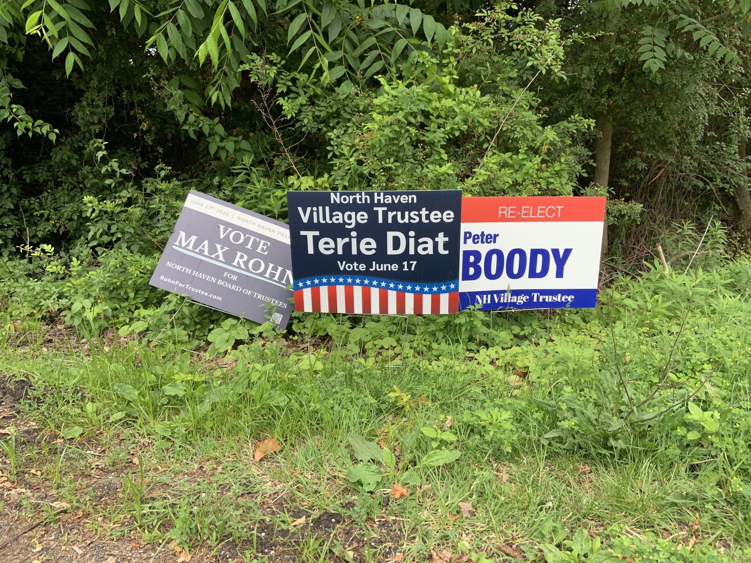 Campaign signs for the three candidate for North Haven Village Board were placed at the Route 114 traffic circle on Tuesday. STEPHEN J. KOTZ