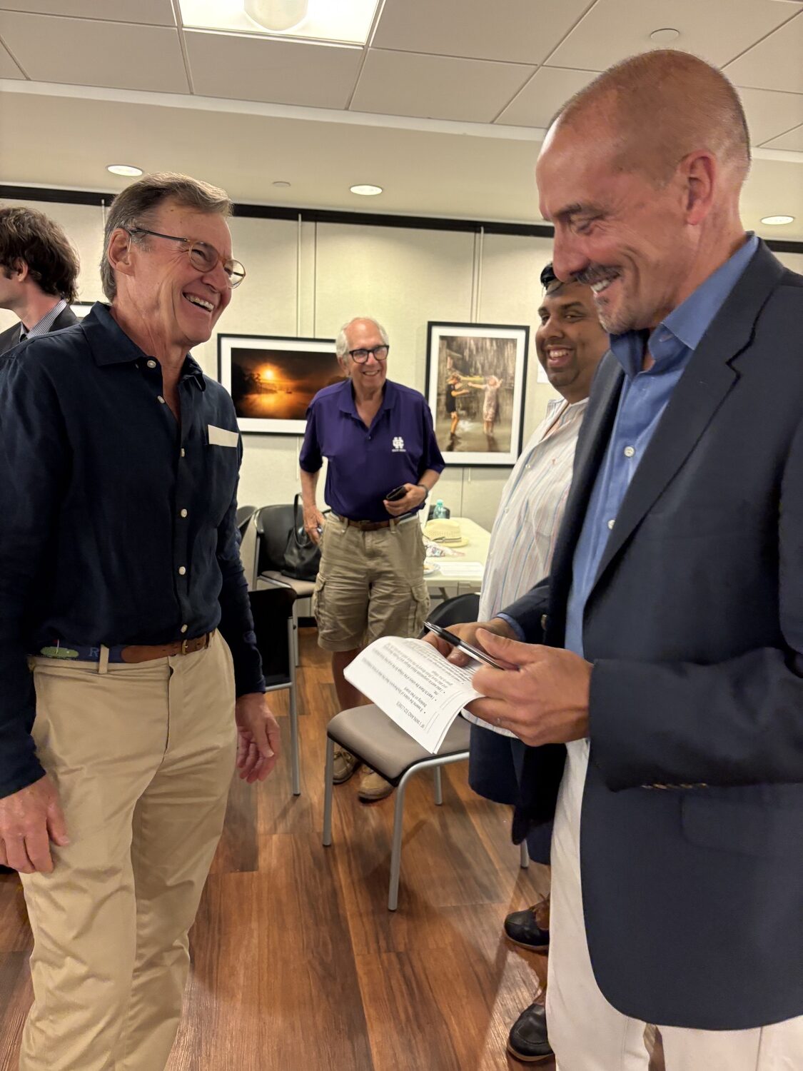 Roy Stevenson, left, congratulates new trustee Rob Coburn. CAILIN RILEY