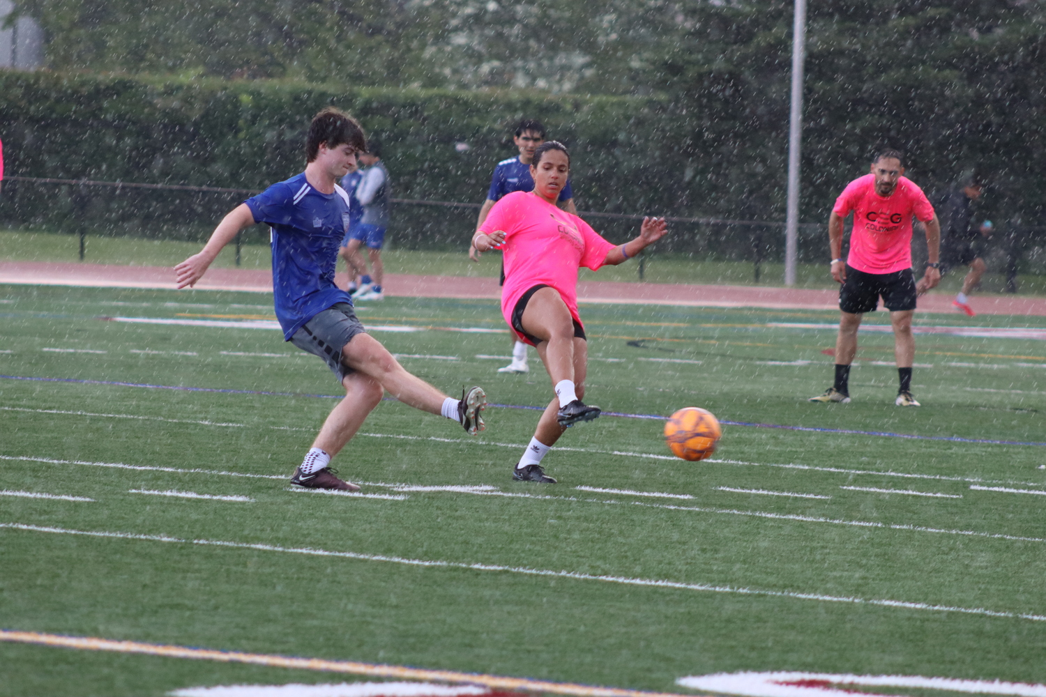 Southampton United players [NAME] sends a shot with coach Laura Burgos on defense. CAILIN RILEY