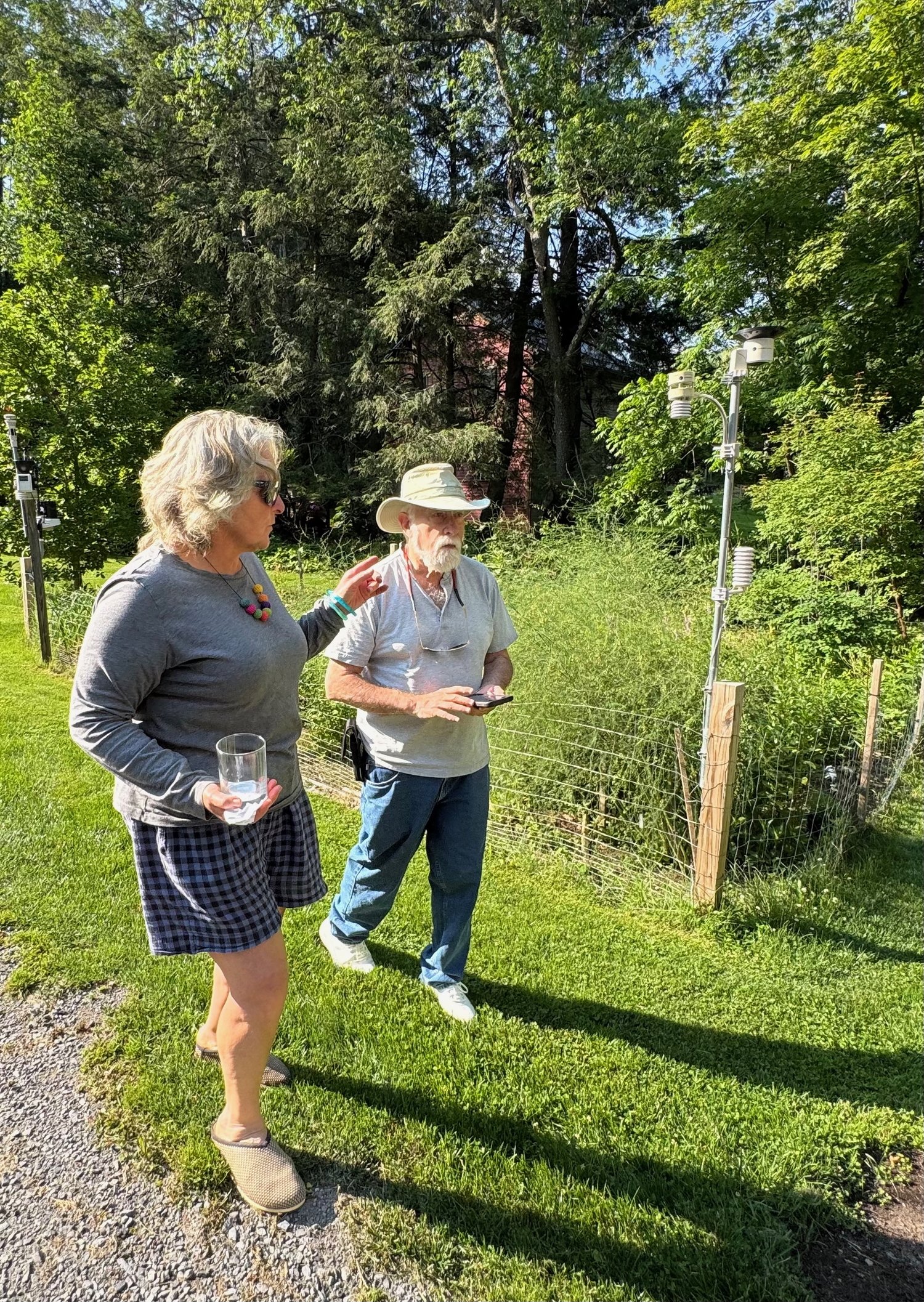 Southampton landscaper and designer April Gonzales and the Hampton Gardener as they are in deep conversation while passing his trial garden.   SARAH DONNELLY