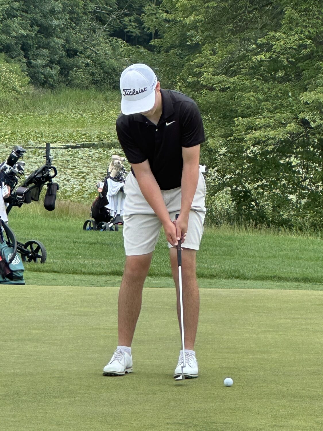 Zach Berger putts at the James Beard State park site of the Federations Boys Golf Championships on Sunday.   JOSH BERGER