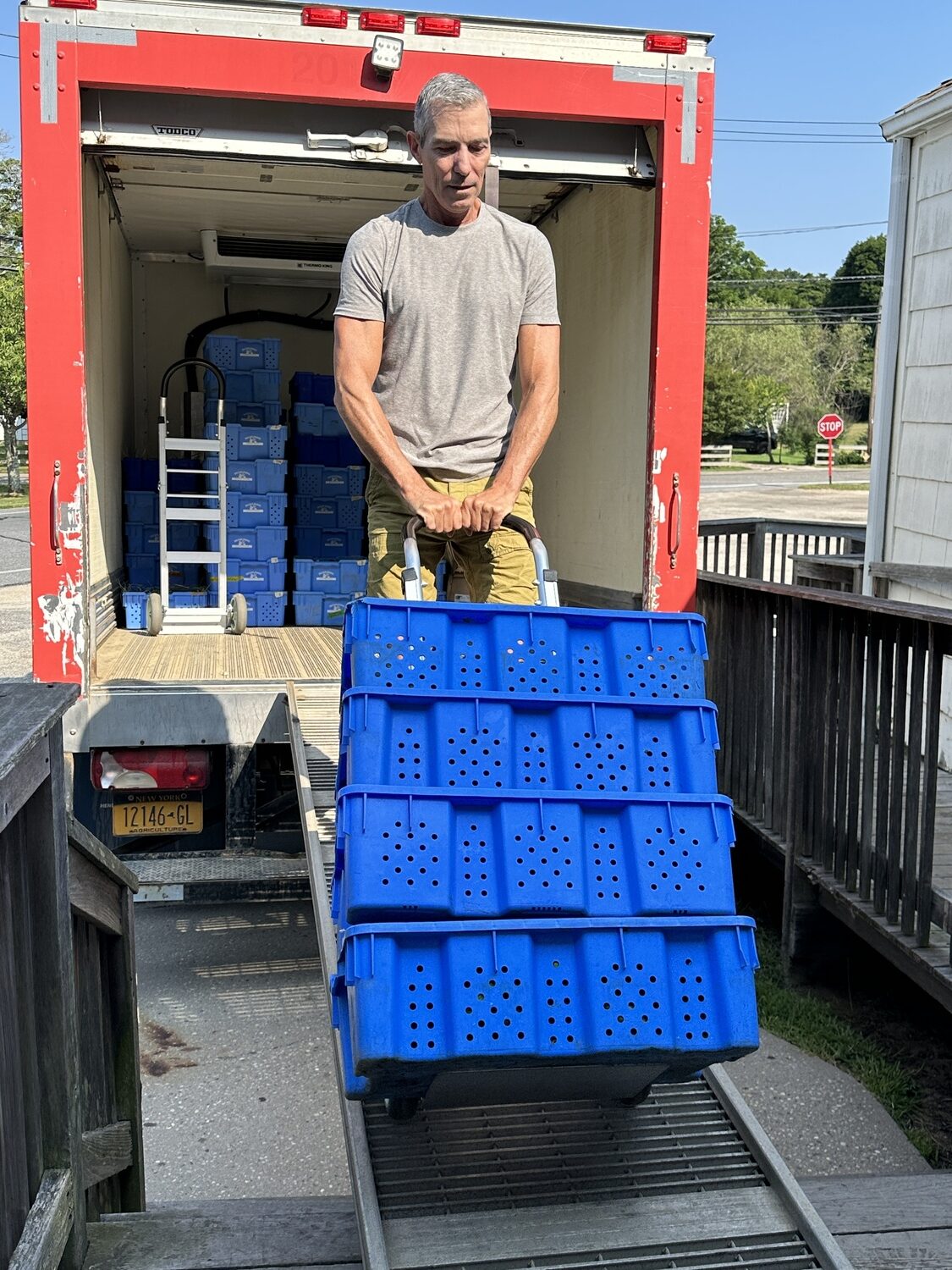 A volunteer with the South Fork chapter of Food Rescue US unload crates of vegetables at the Springs Food Pantry. Food Rescue US- South Fork photo
