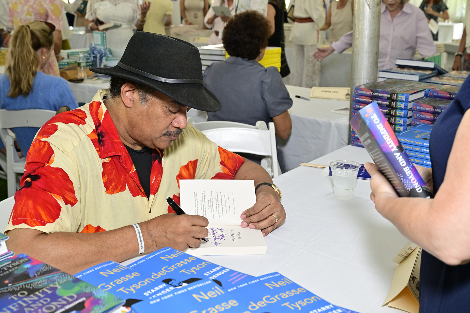 Neil deGrasse-Tyson signs copies of his book at Author's Night. Photo courtesy Eugene Gologursky | Getty Images