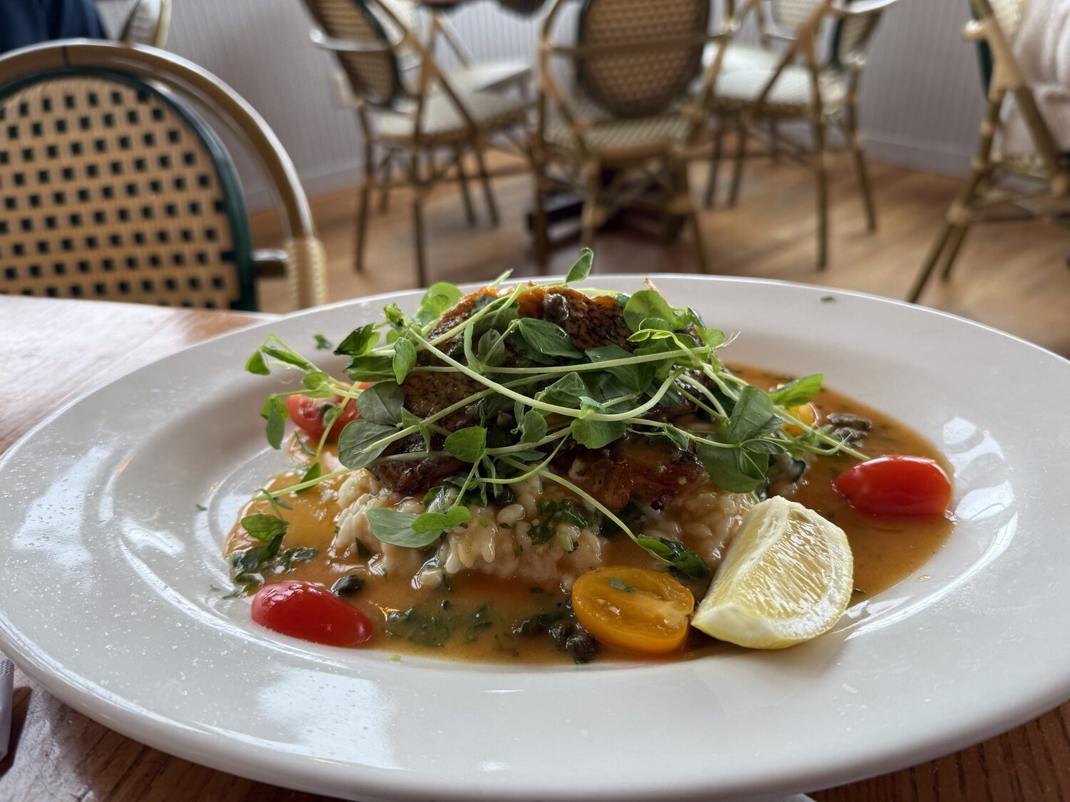 Pan-Seared Sea Bass with Spinach Risotto and Lemon Caper Sauce from Chef Fermin Jiminez of Inlet Seafood in Montauk.
