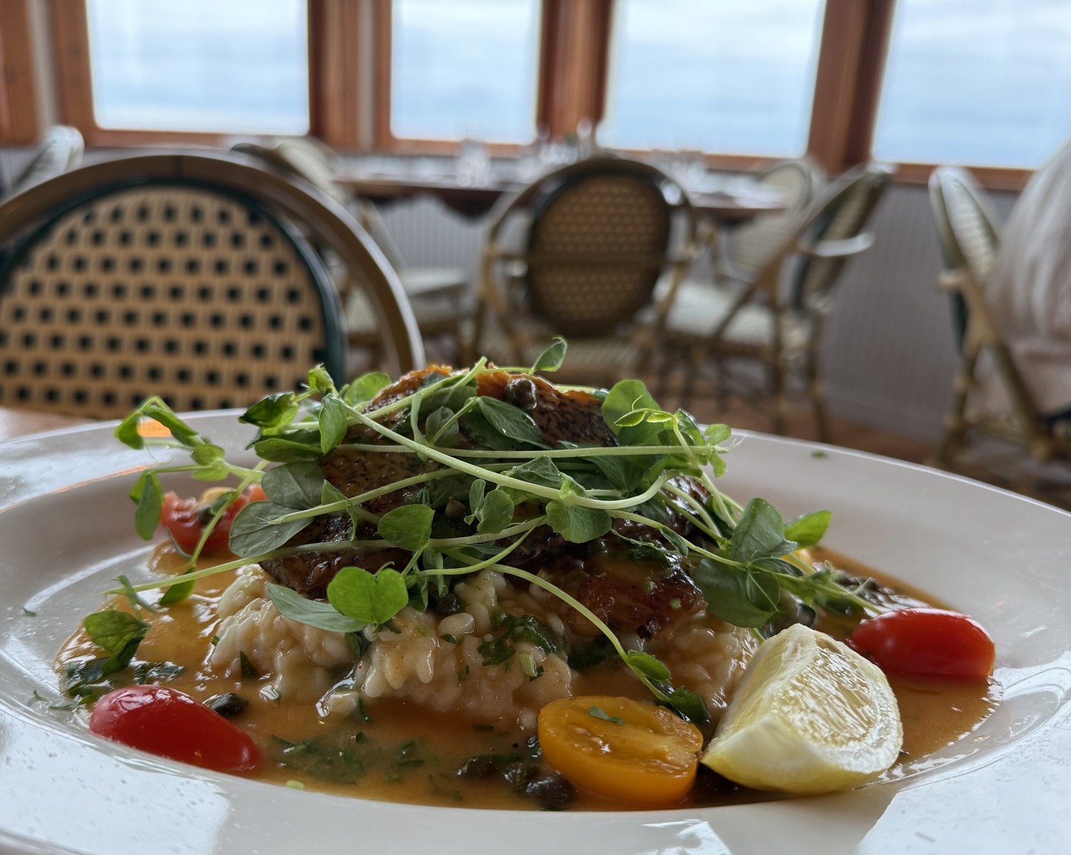 Pan-Seared Sea Bass with Spinach Risotto and Lemon Caper Sauce from Chef Fermin Jiminez of Inlet Seafood in Montauk.