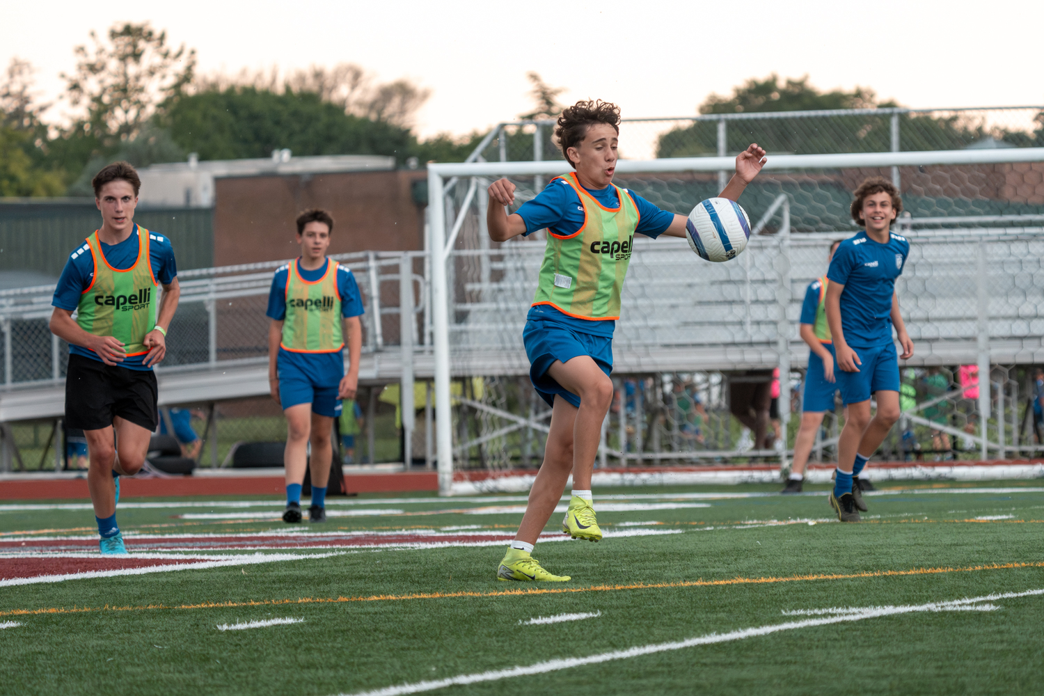 Southampton Town United players, parents and coaches gathered at Southampton High School on Friday night for the club's annual soccer festival. The club includes players from age 3 to 18, and had 26 travel teams compete in the Long Island Junior Soccer League this spring. The festival's main event, a game on the turf featuring the oldest club team, with players born in 2007, against coaches in the club, was named in honor of former coach Sean Collins this year. Collins died on May 2 after a battle with cancer. RON ESPOSITO