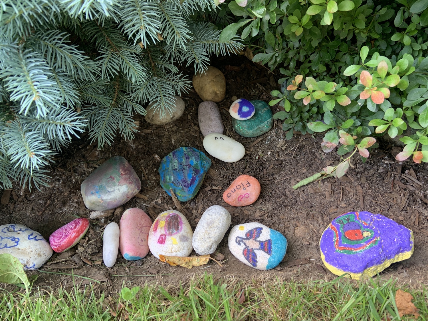 Children left stones they had painted in the garden behind the Bridgehampton Citarella store at the East End Fund for Children's annual kickoff party. STEPHEN J. KOTZ