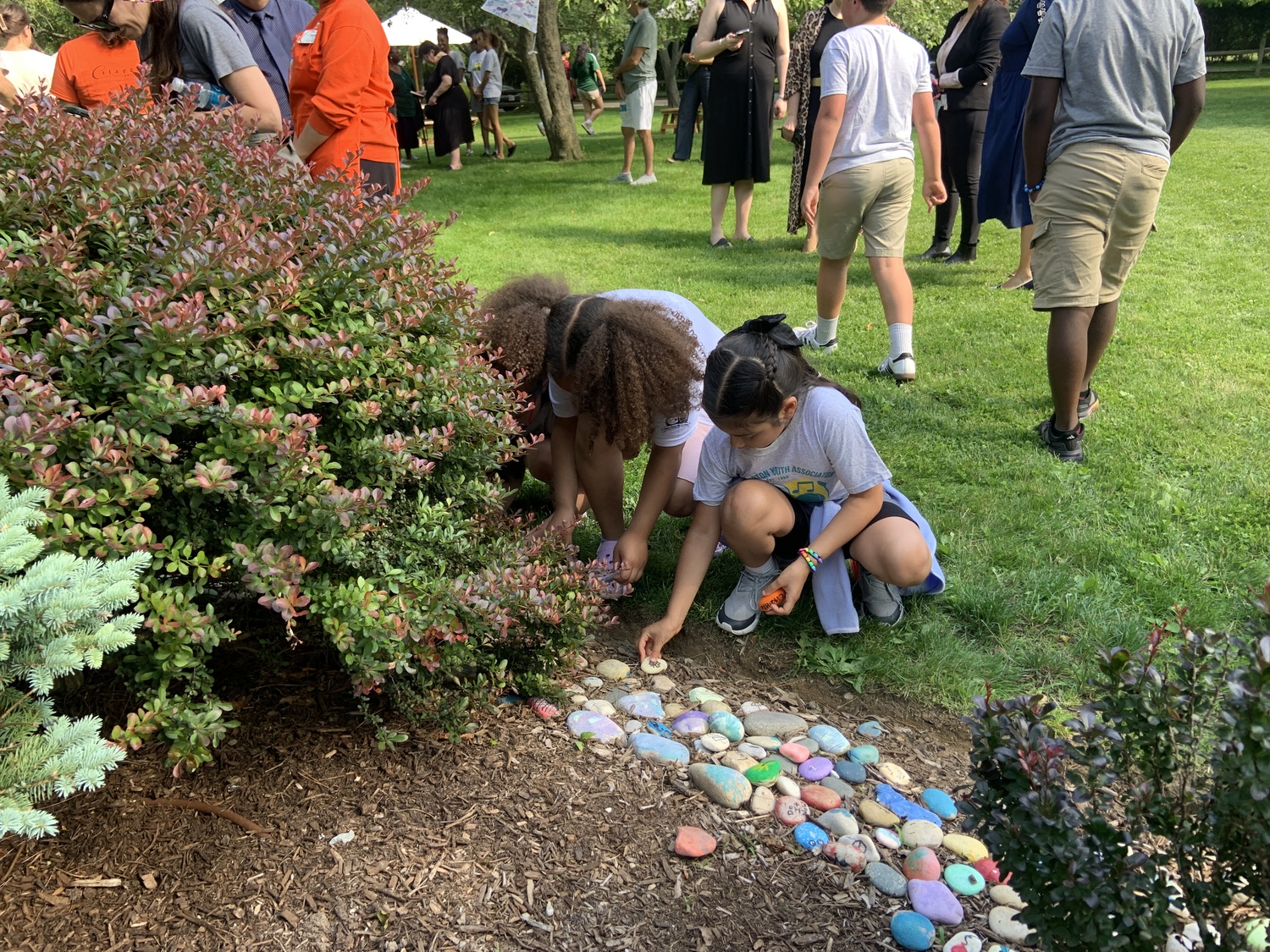 Children placed painted stones in the garden behind the Citarella store in Bridgehampton as the East End Fund for Children kicked off its annual fundraising drive. STEPHEN J. KOTZ
