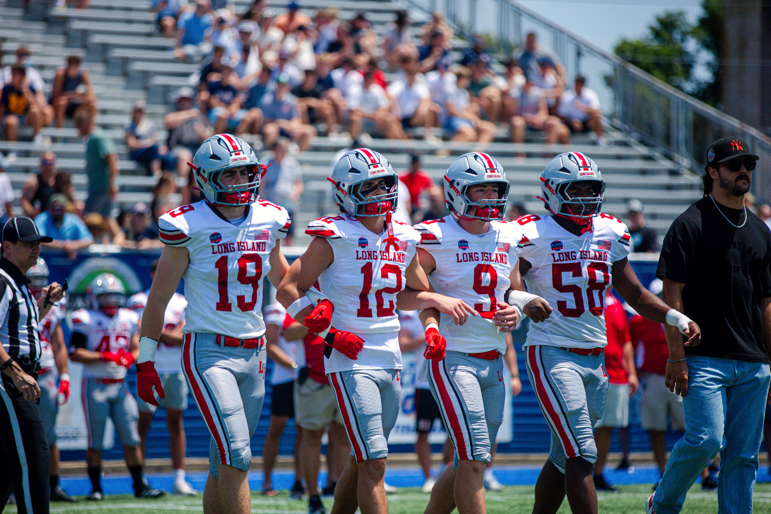Westhampton Beach senior Brody Schaffer walks to center field with the Long Island captains during the inaugural National Football Foundation All-Star Classic. MAYA FARNAN MEDIA