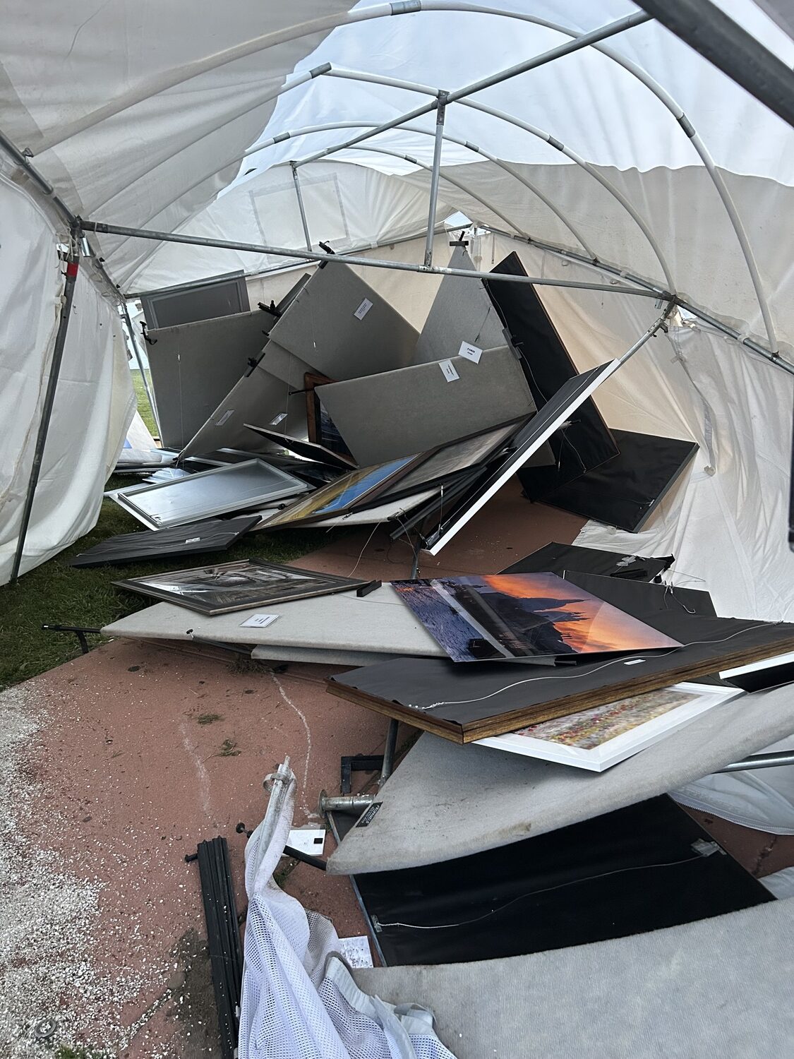 Jim Levison's tent filled with photographs, some framed in expensive wooden frames, others printed on aluminum, took a direct hit from the car. JIM LEVISON
