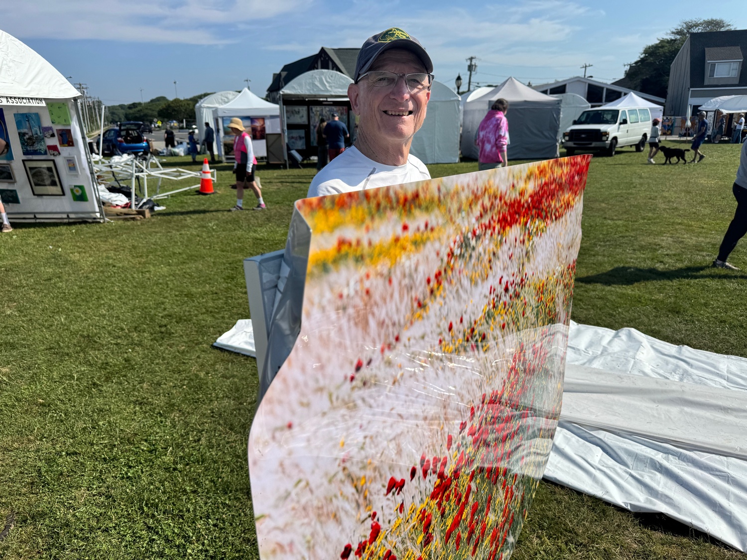 Jim Levison lost numerous prints of his photographs on aluminum panels when the car smashed through his tent just before striking a parked car. MICHAEL WRIGHT