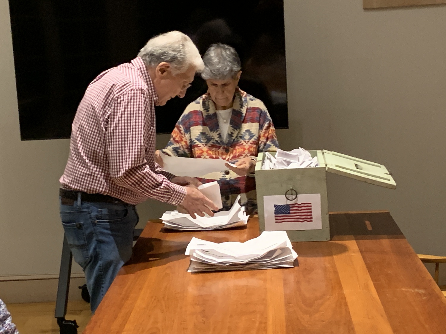 Poll workers Ronald and Mary Anne Mango begin the task of organizing paper ballots for the vote count in North Haven on Tuesday. STEPHEN J, KOTZ