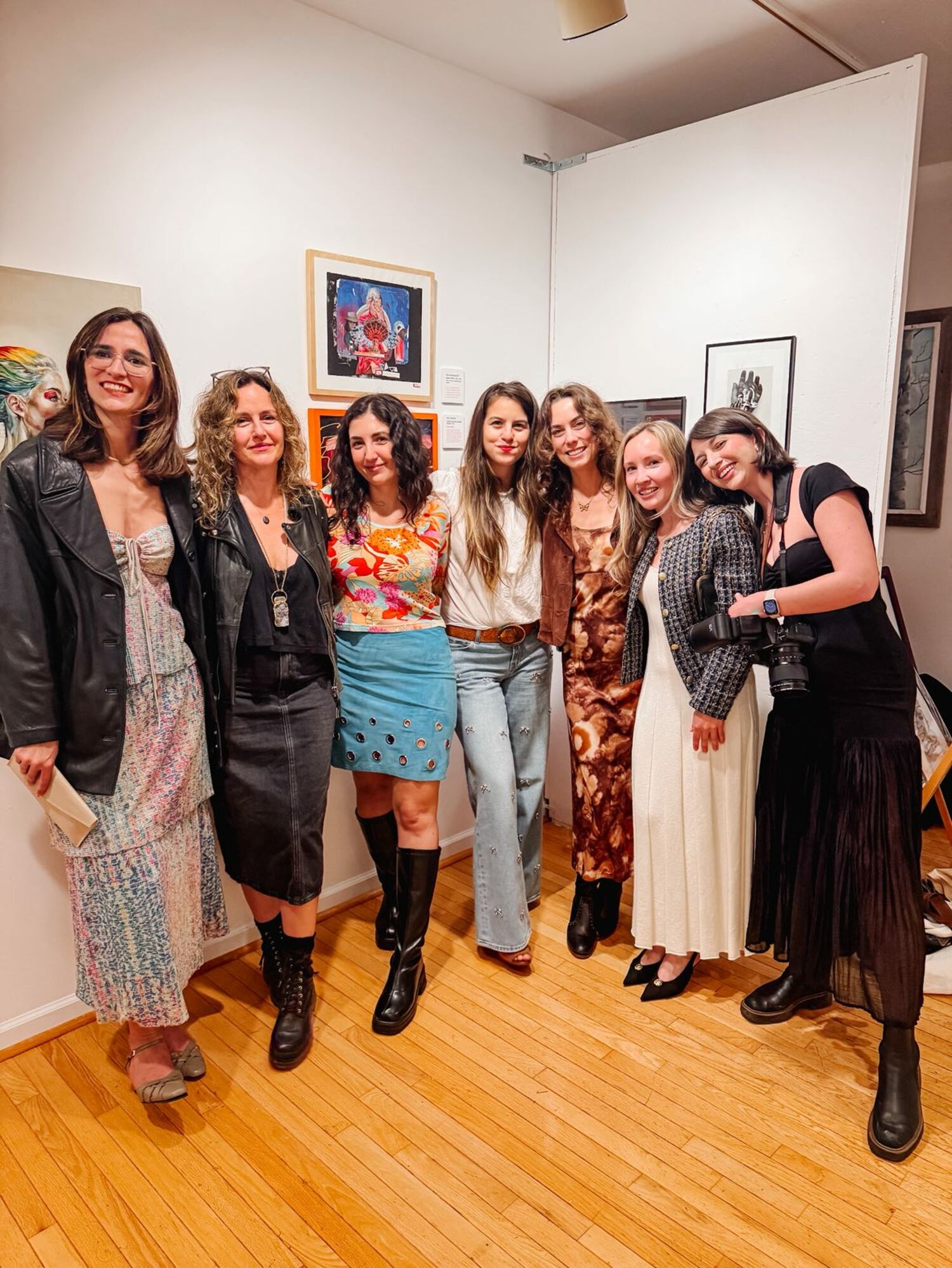 Female artists, including North Fork Art Collective co-founder Kara Hoblin (center), celebrate the opening of 