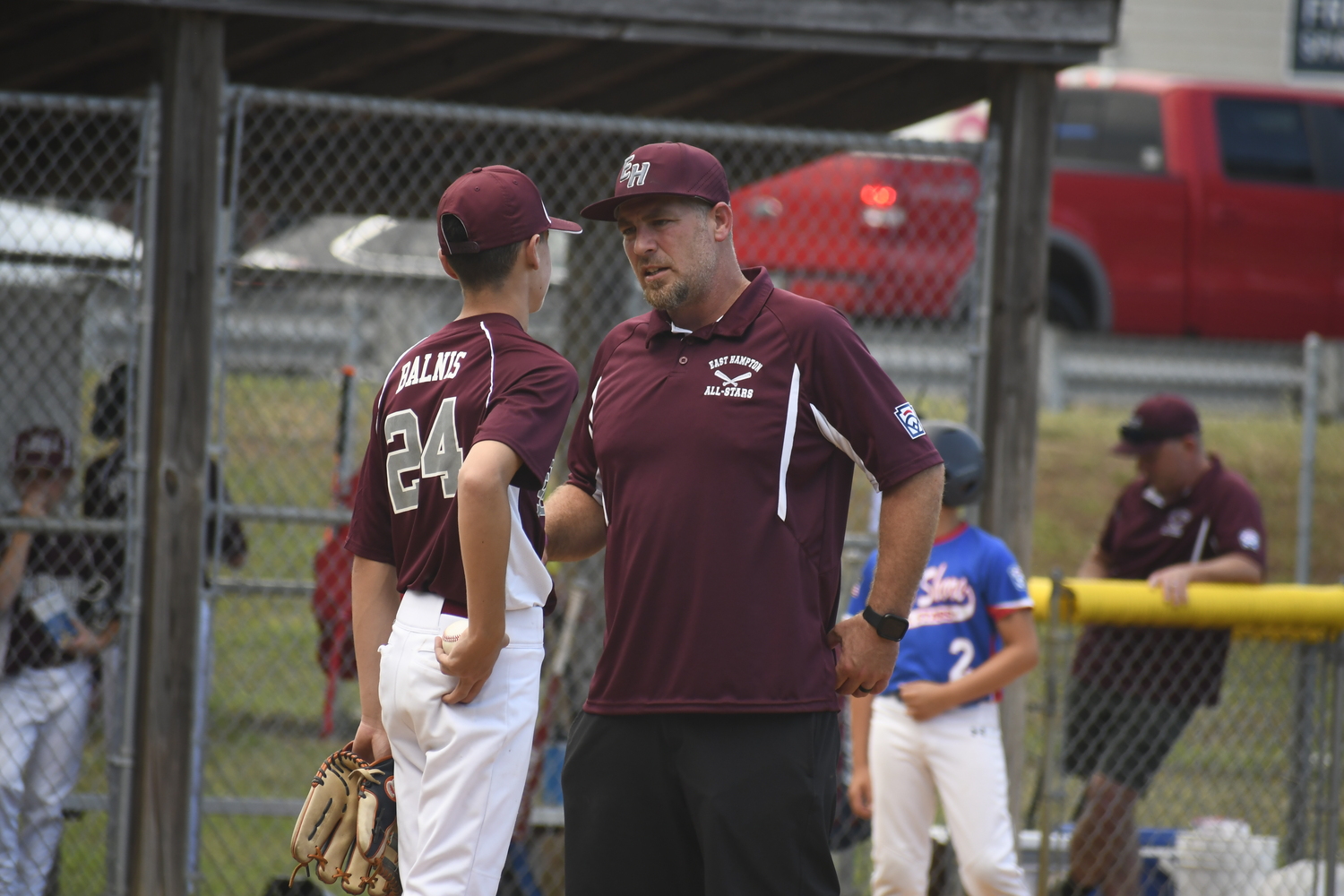 Coach Rob Possillico speaks with starting pitcher James Balnis.  DREW BUDD