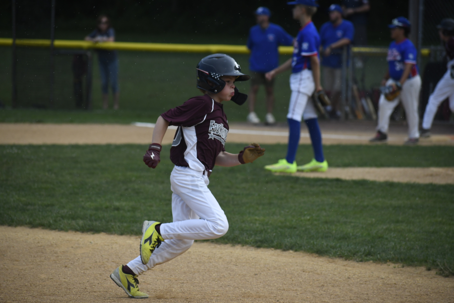 Dixon Bennett runs through the rain drops and rounds third base.  DREW BUDD