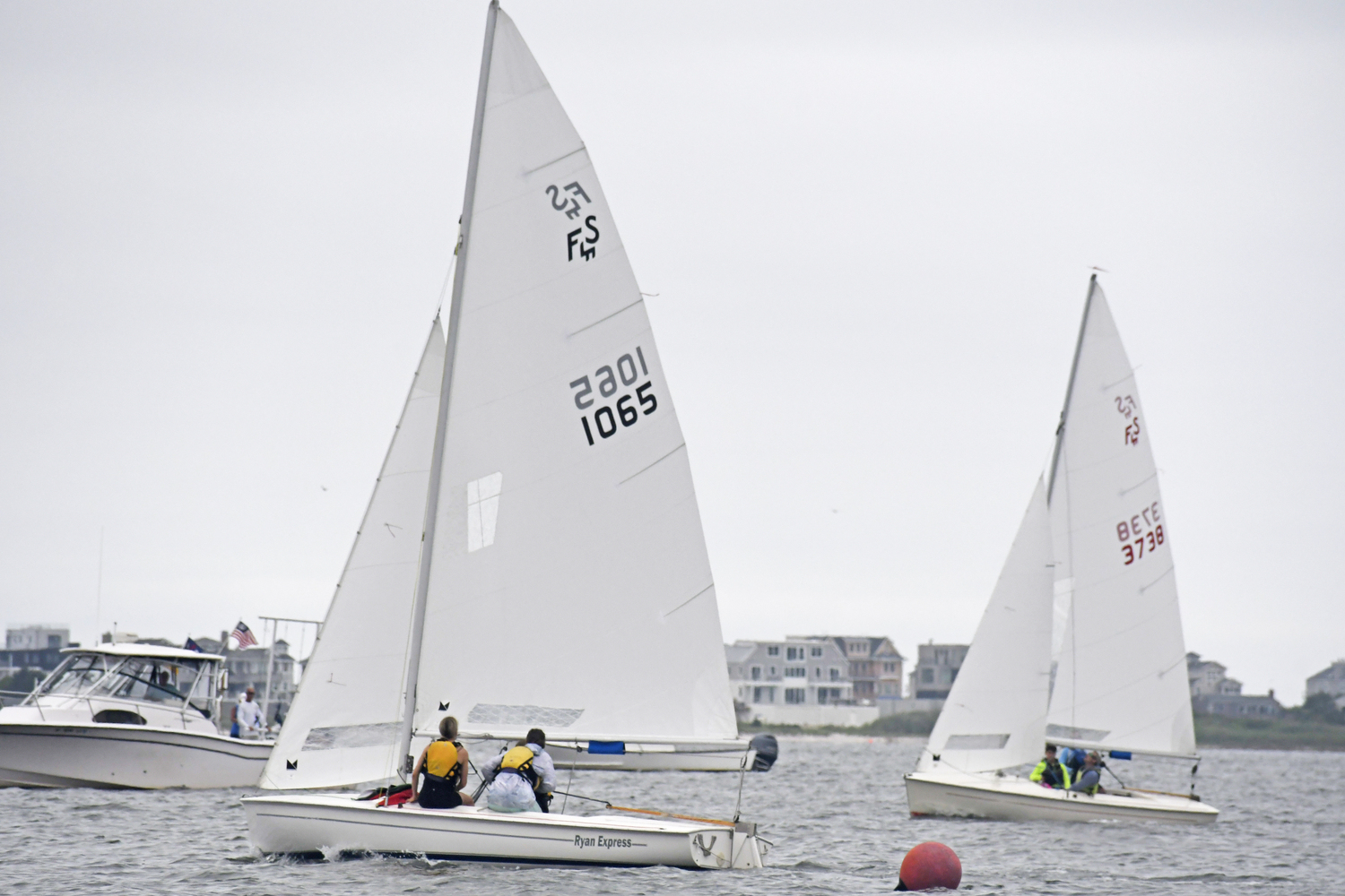 Wally, Paula and Ava Dawydiak cross the finish line ahead of Jim Schultz and Mike and Blake DiSario.  DREW BUDD