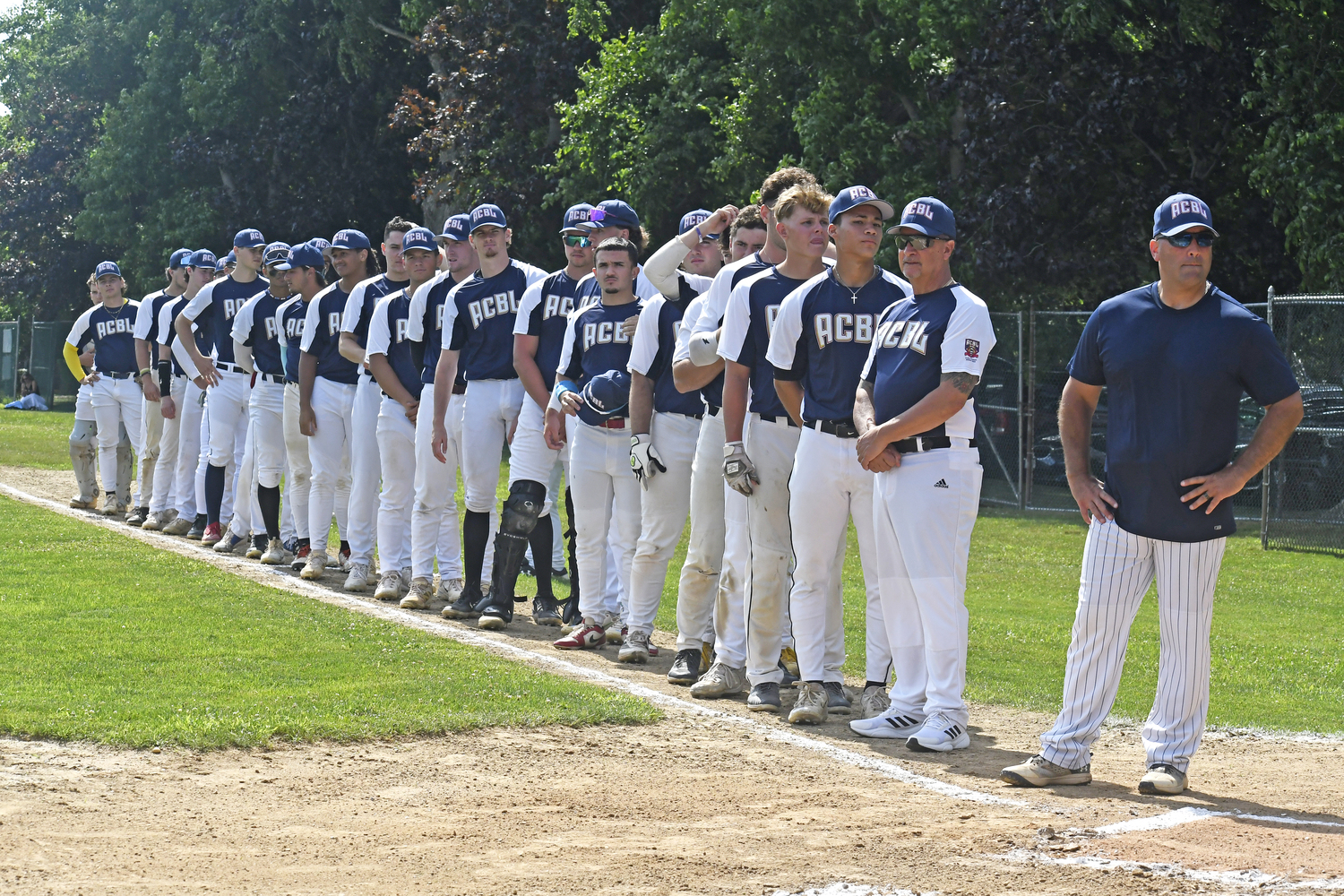 The Atlantic Collegiate Baseball League All-Stars line up on the first base line during pregame ceremonies.  DREW BUDD
