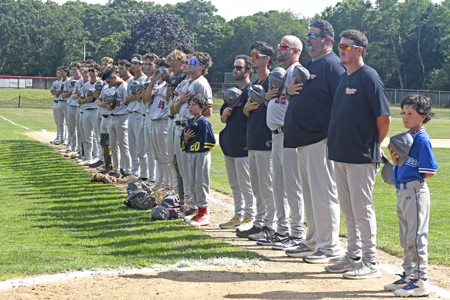 The HCBL All-Stars line up along the third base line for the pregame ceremony.  DREW BUDD