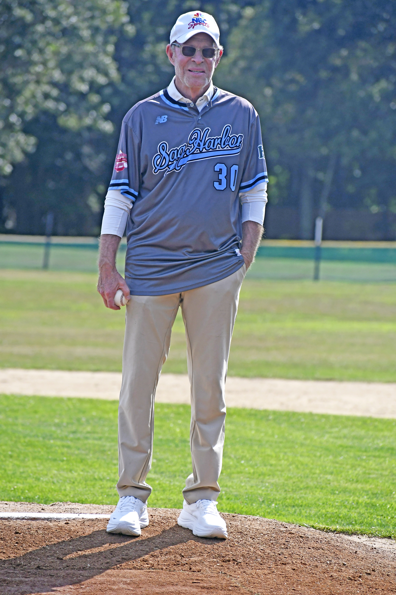 Michael Weisman, who worked for NBC Sports and was inducted into the Sports Broadcasting Hall of Fame in 2017, gets set to throw out the first pitch on Saturday afternoon.  DREW BUDD